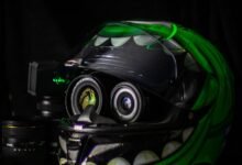 black and green full-face helmet on white wooden table