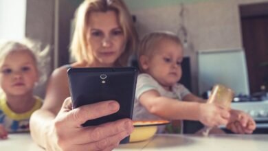 woman in white shirt holding black ipad